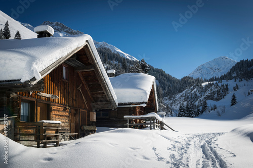 wooden houses on austrian mountains at winter with a lot of snow #49529107