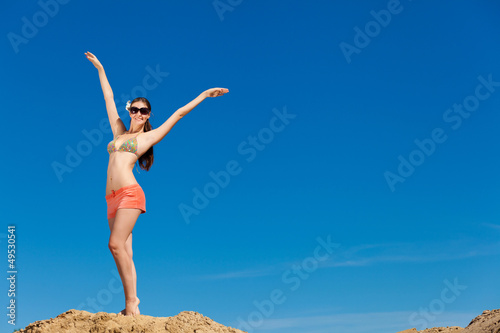 Portrait of young woman in bikini at beach