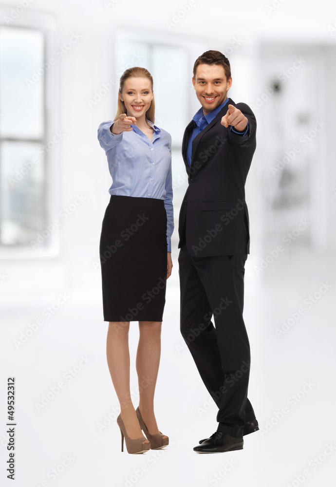 man and woman pointing their fingers man and woman pointing their fingers
