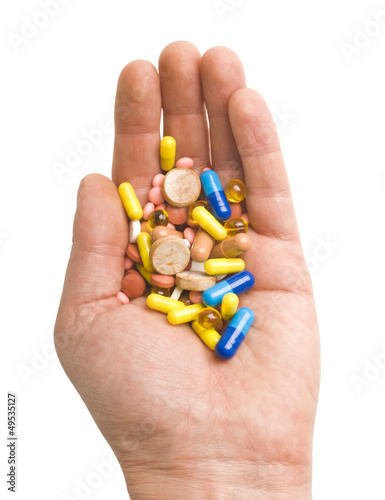 Hand with colorful pills