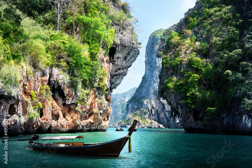 long boat and rocks on railay beach in Krabi, Thailand