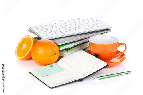 Orange fruits, coffee cup and office supplies