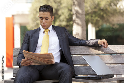 Businessman reading his newspaper