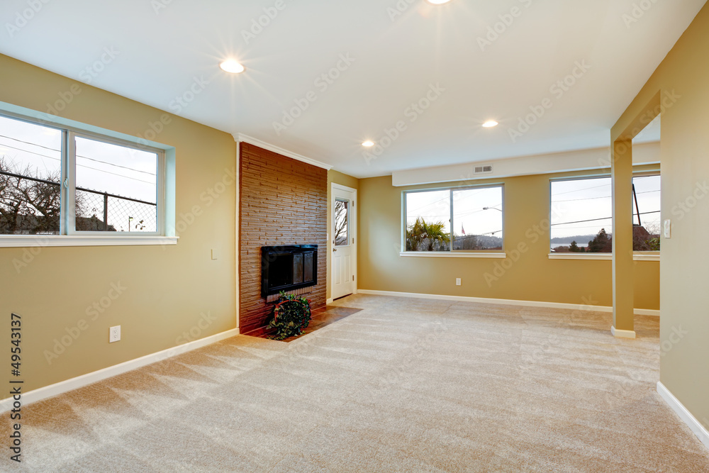 New liiving room with fireplace and many windows.
