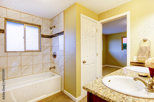 New bathroom interior with cherry sink cabinet.