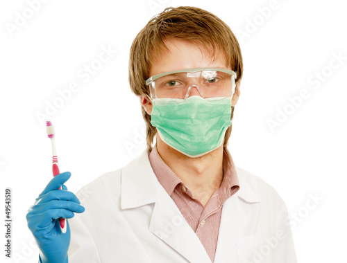 A male dentist with a toothbrush