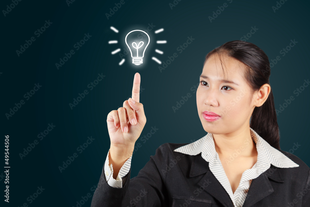 Business woman touch screen with lamp symbol. For business conce Business woman touch screen with lamp symbol. For business conce