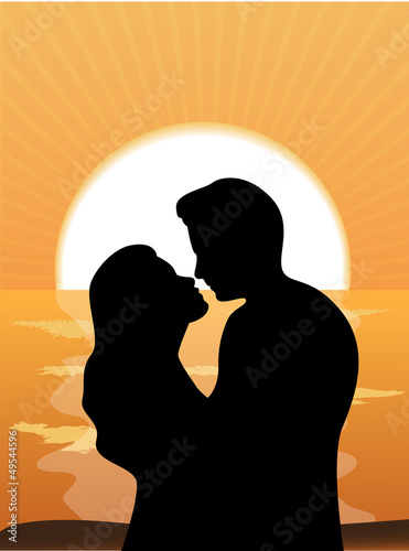 silhouettes of loving couple at sunset