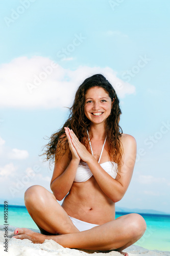 Portrait of a happy young woman posing while on the beach