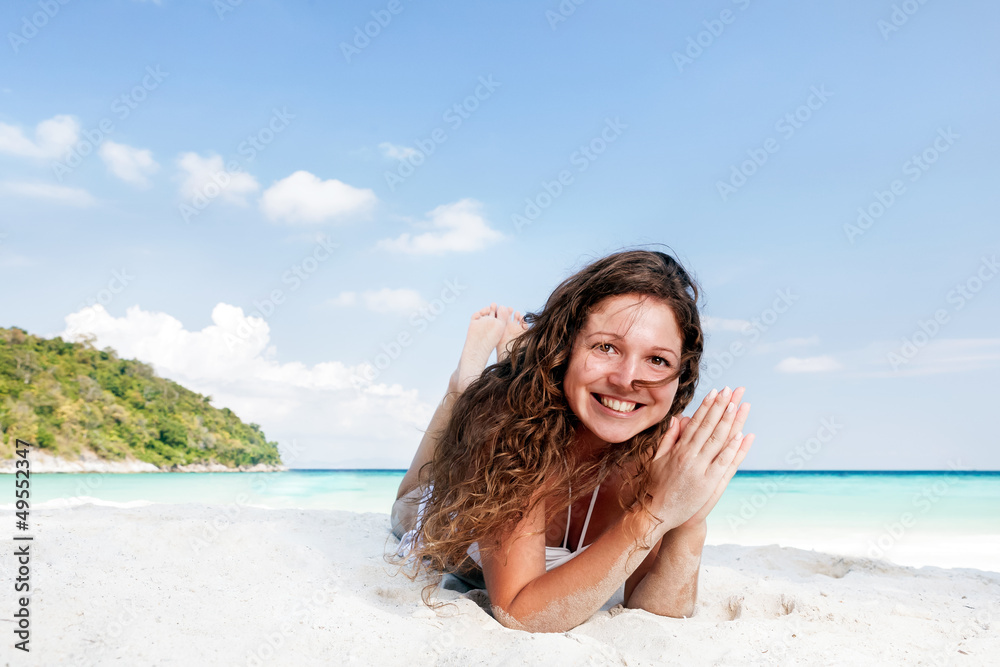 Portrait of a happy young woman posing while on the beach Portrait of a happy young woman posing while on the beach