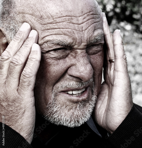 Senior man suffering from severe headache
