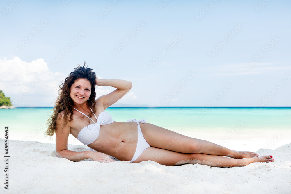 Portrait of a happy young woman posing while on the beach Portrait of a happy young woman posing while on the beach