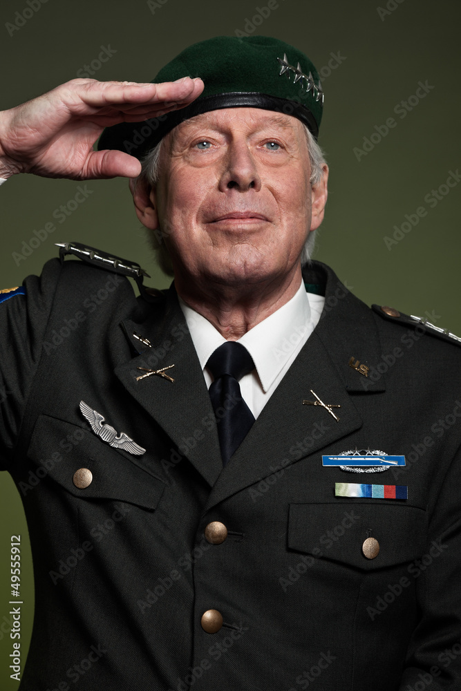 US military general wearing beret. Salutation. Studio portrait. US military general wearing beret. Salutation. Studio portrait.