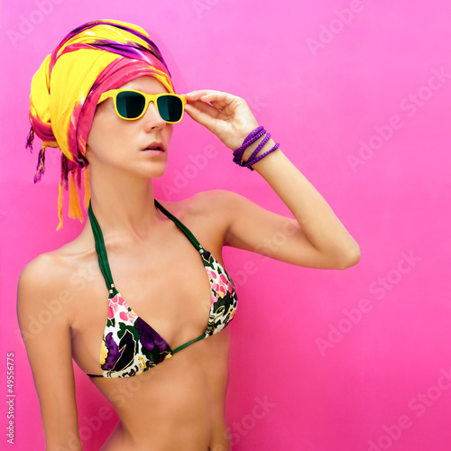 portrait of a girl in a scarf and a bright swimsuit
