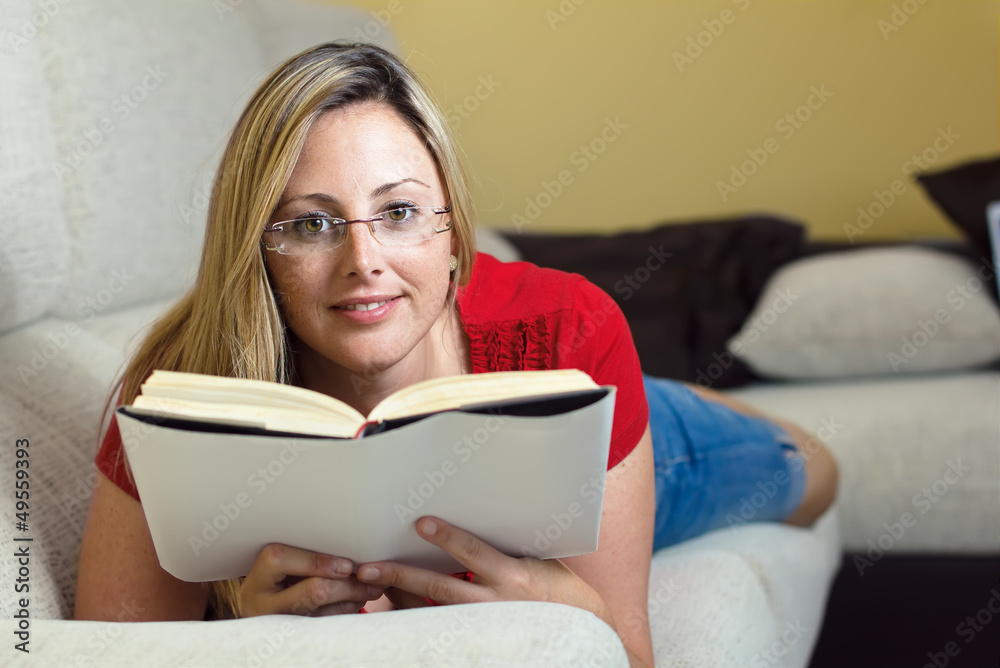 woman reading a book lying woman reading a book lying