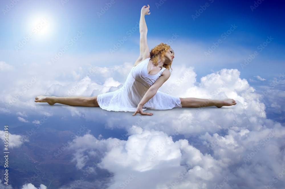 Ballerina seating on the sky clouds