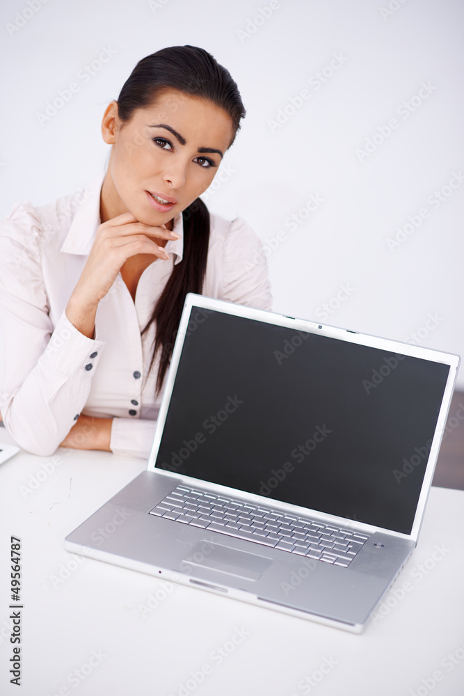 Business woman sitting at her desk with laptop Business woman sitting at her desk with laptop