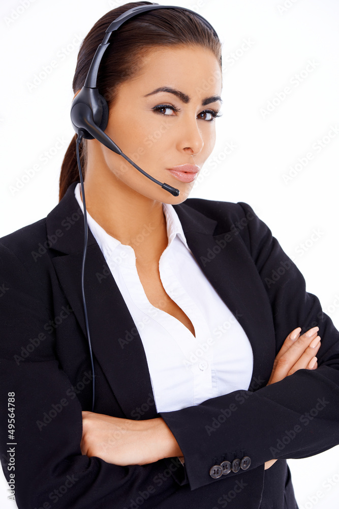 Business woman standing with arms crossed, wearing headset Business woman standing with arms crossed, wearing headset