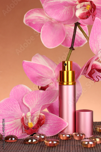 Women's perfume in beautiful bottle with orchids