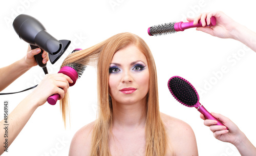 Beautiful woman and hands with brushes, scissors and hairdryer