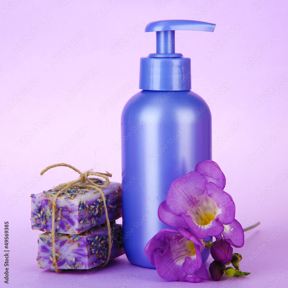 Liquid and hand-made soaps on purple background Liquid and hand-made soaps on purple background