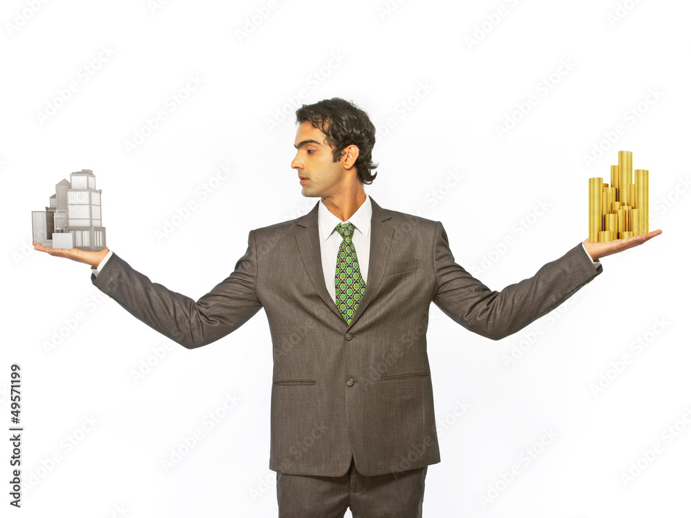 Business man balancing coin and building Business man balancing coin and building