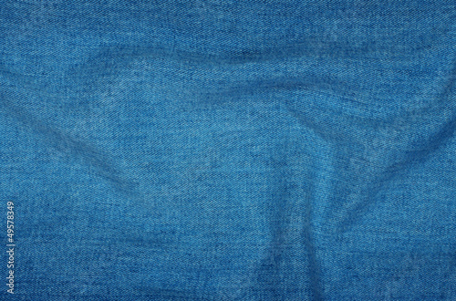 Background of blue denim with folds