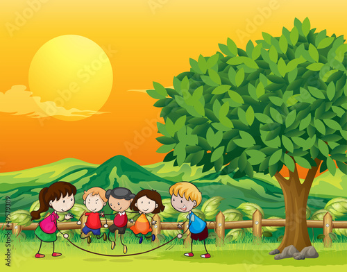 Five children playing jumping rope