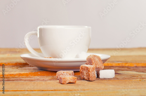 Image of coffee cup in front of sugar pieces photo