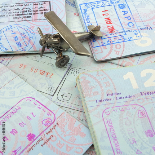 Passports and toy airplane photo