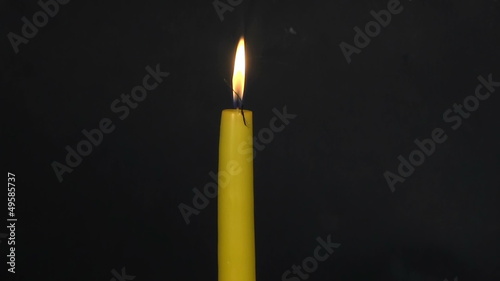 Burning-down yellow candle. Time lapse 1