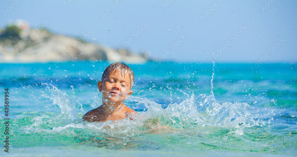 Young boy swimming in sea