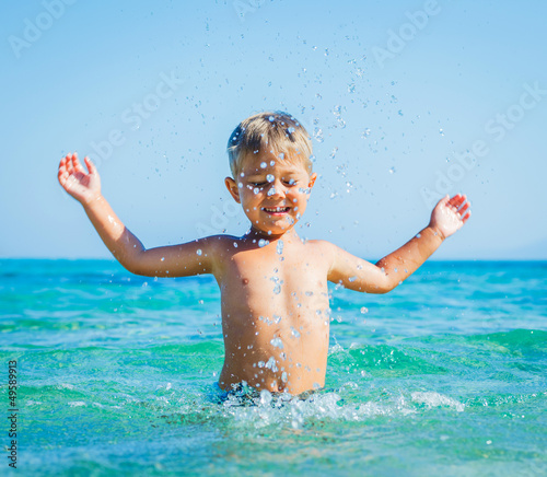 Young boy swimming in sea photo