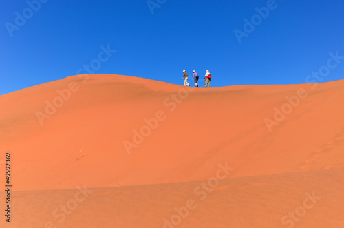 People walking on dune, Namib desert, traveling in South Africa