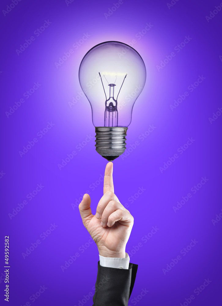 Light bulb on tip of finger on businessman Light bulb on tip of finger on businessman