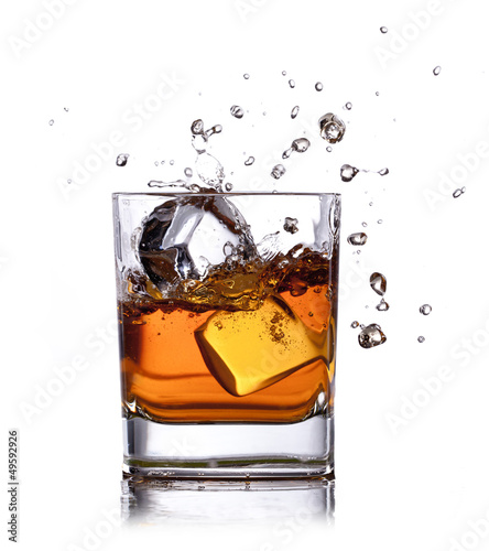 whiskey splash with ice cubes isolated on white