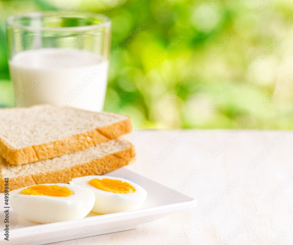 Boiled eggs, toasts and glass of milk Boiled eggs, toasts and glass of milk