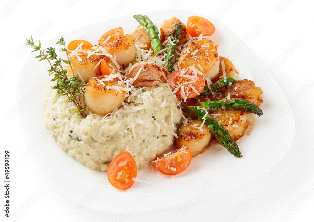 Risotto with pan seared sea scallops isolated on white Risotto with pan seared sea scallops isolated on white