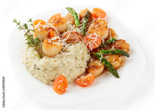 Risotto with pan seared sea scallops isolated on white