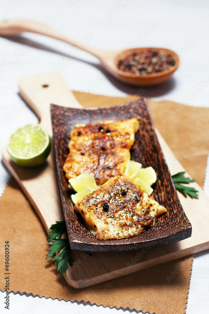 Fried white fish, served with lime, selective focus