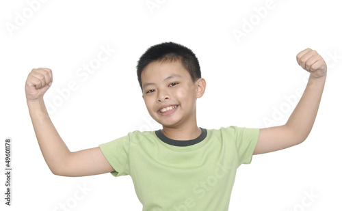 little boy flexing biceps isolated against white background