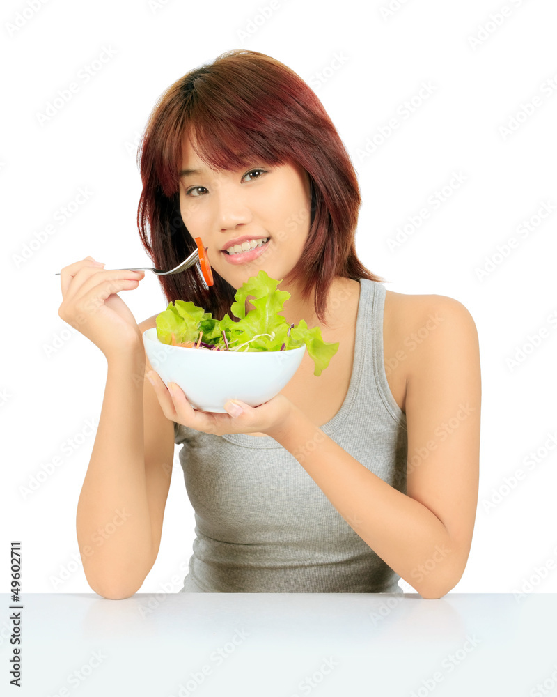 Isolated young asain woman with a bowl of vegetable salad Isolated young asain woman with a bowl of vegetable salad