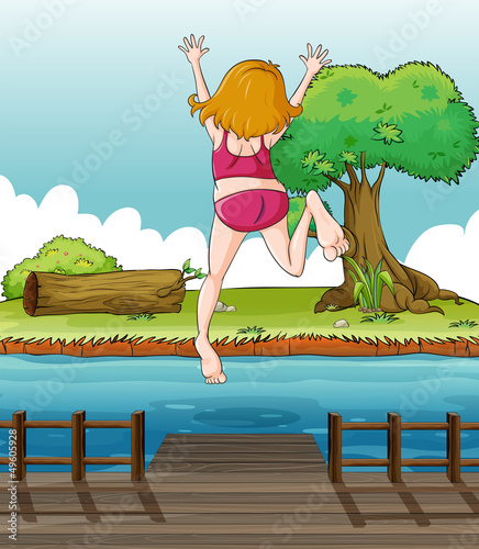 A girl jumping at the wooden bridge