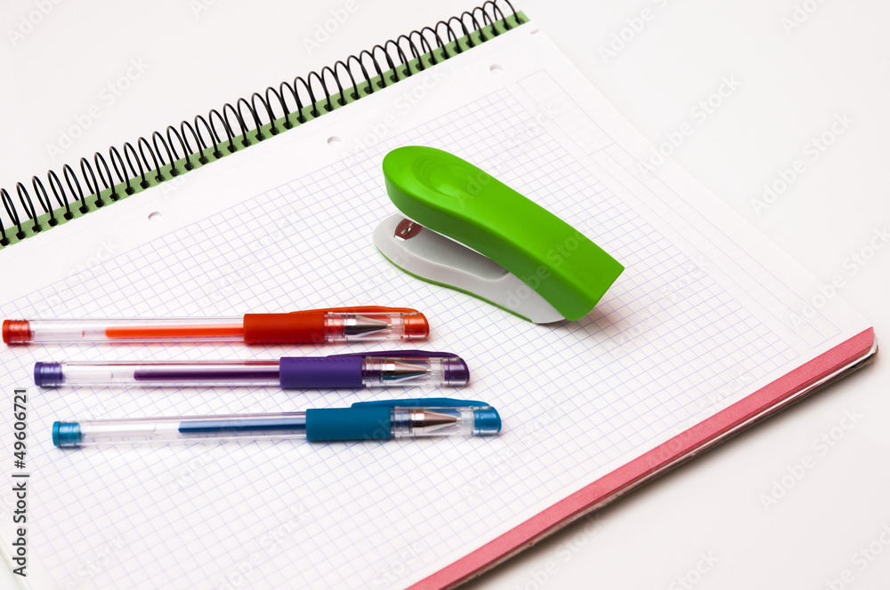 book with pens and stapler book with pens and stapler