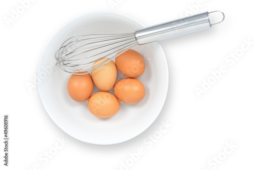 fresh eggs with whisk, isolated on white