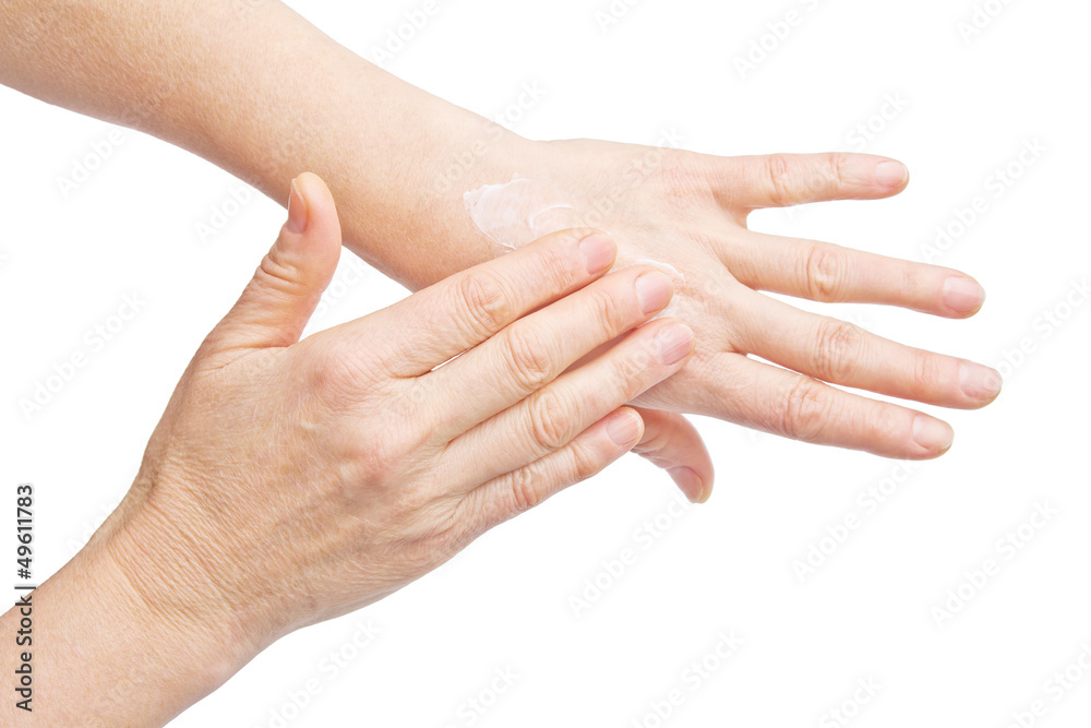 Female hands applying hand cream isolated on white background Female hands applying hand cream isolated on white background
