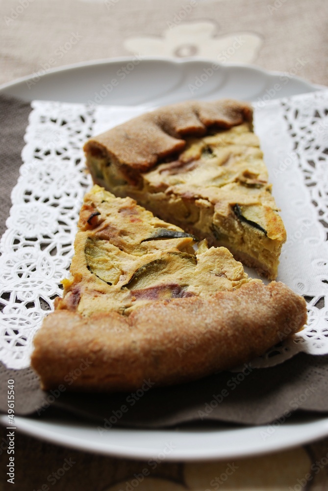 Two slices of vegetarian tart with zucchini, onion and tofu Two slices of vegetarian tart with zucchini, onion and tofu