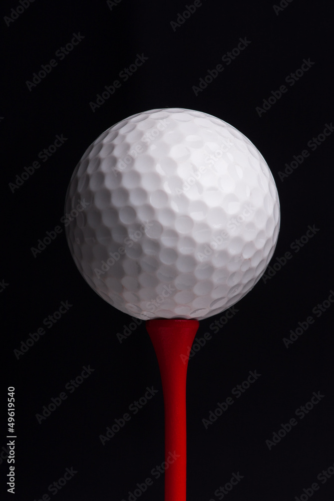 golf tees with ball on black background golf tees with ball on black background
