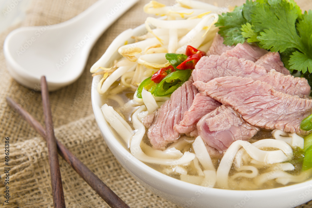 Pho Bo - Vietnamese rice noodle soup with beef, herbs and chili Pho Bo - Vietnamese rice noodle soup with beef, herbs and chili
