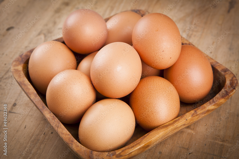 eggs in a bascket on wooden table eggs in a bascket on wooden table